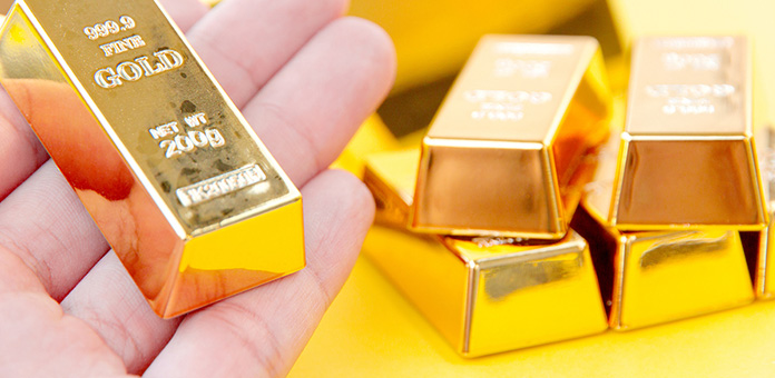 gold bullion bar in hand