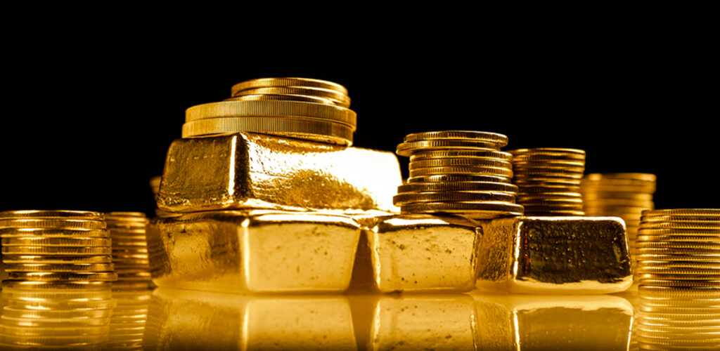 gold bullion bars and coins stacked