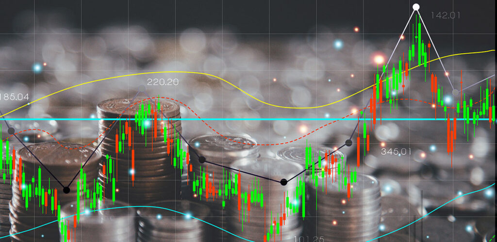 silver coins behind price chart