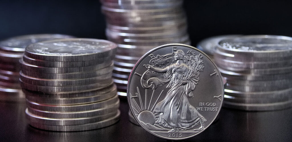 stack of silver coins and silver eagle